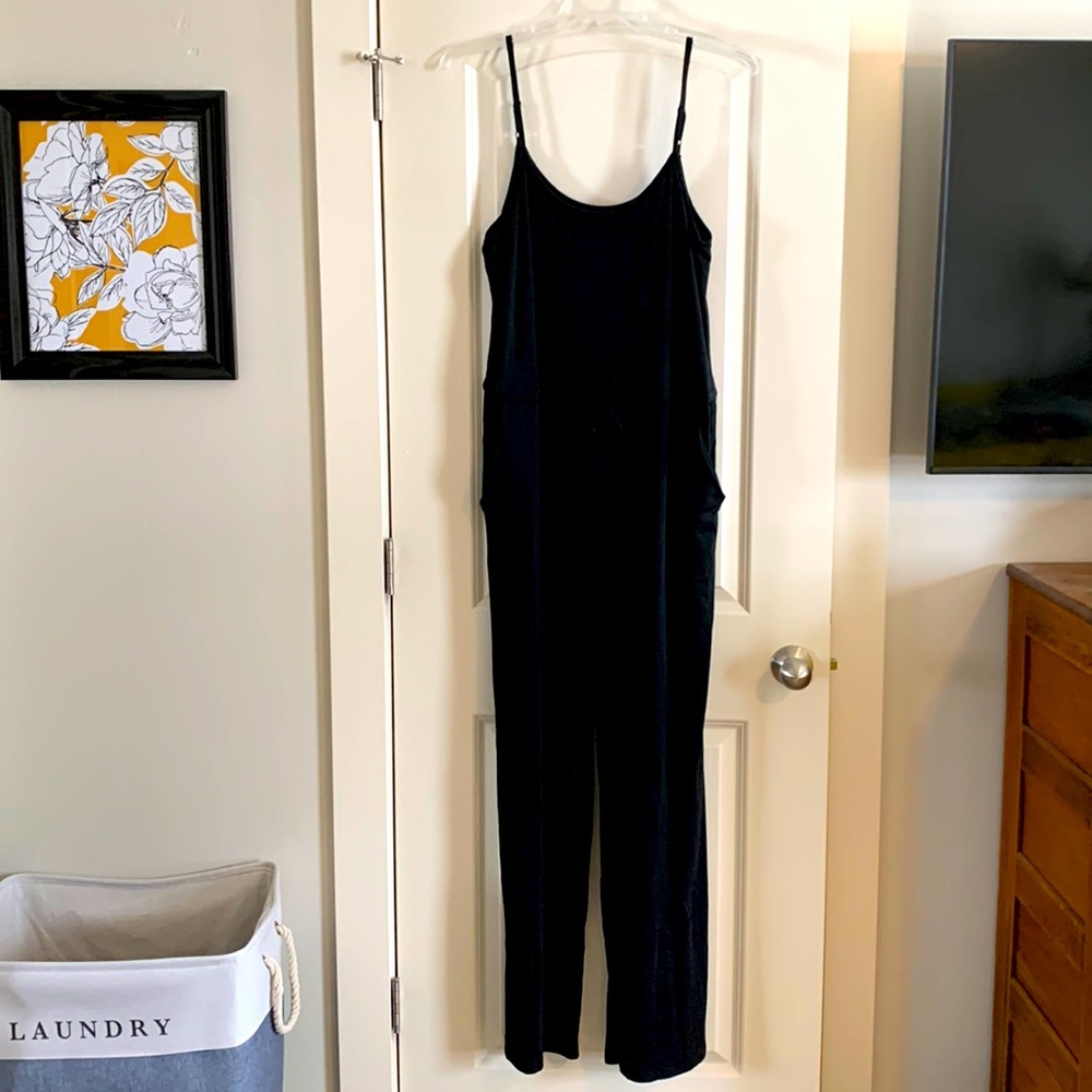 3X black jersey jumpsuit with pockets and waist tie.